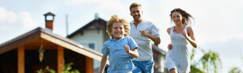 happy family running with home in background